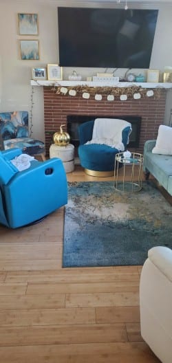 Living room with brick fireplace and blue recliner