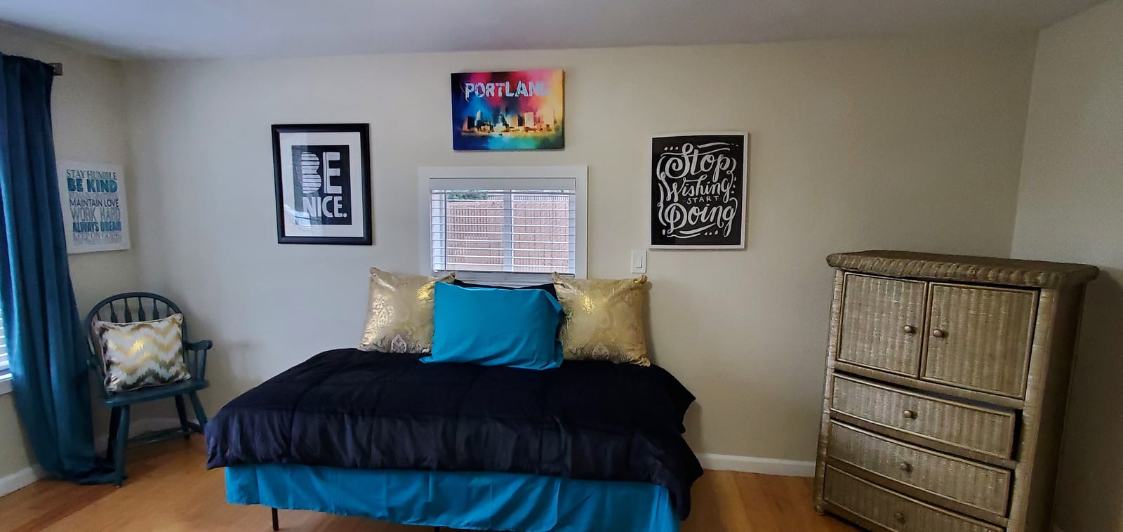 Bedroom with navy bedding and Portland artwork